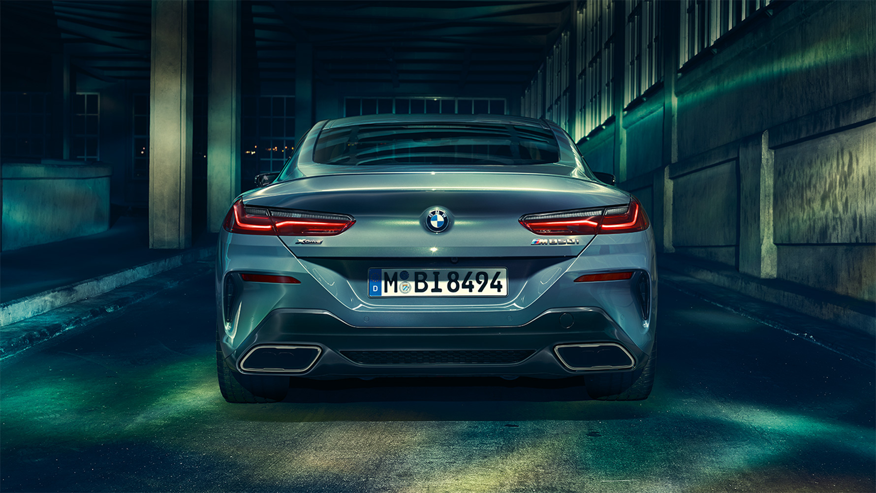 BMW serije 8 Coupé, stražnji prikaz Stražnji prikaz BMW-a serije 8 Coupé noću u urbanoj sredini.