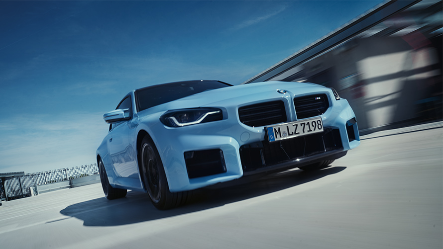 BMW M2 G87 pogled sprijeda vožnja ulicom BMW serije M BMW M2 G87 pogled sprijeda vožnja ulicom